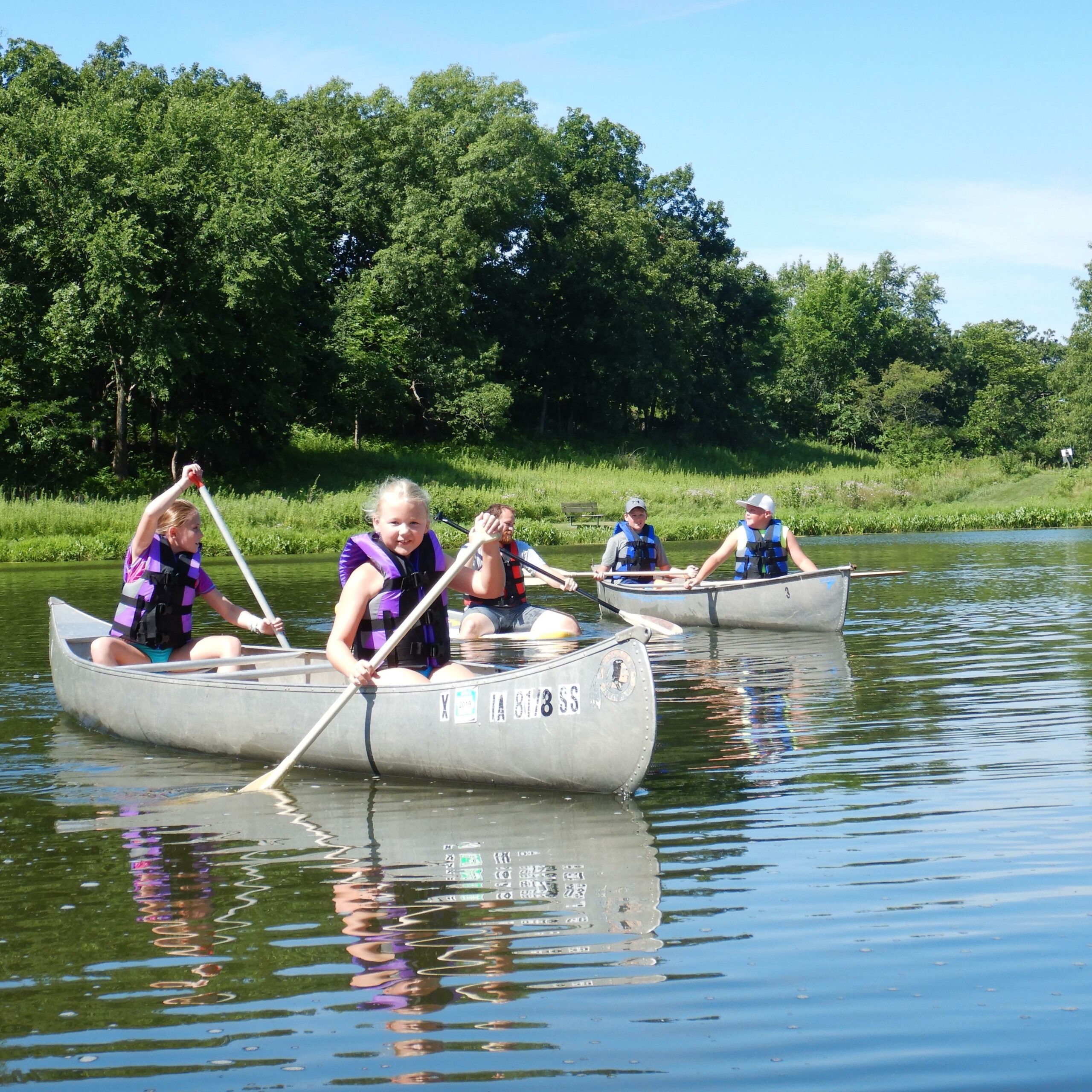 Kids canoeing on a pond